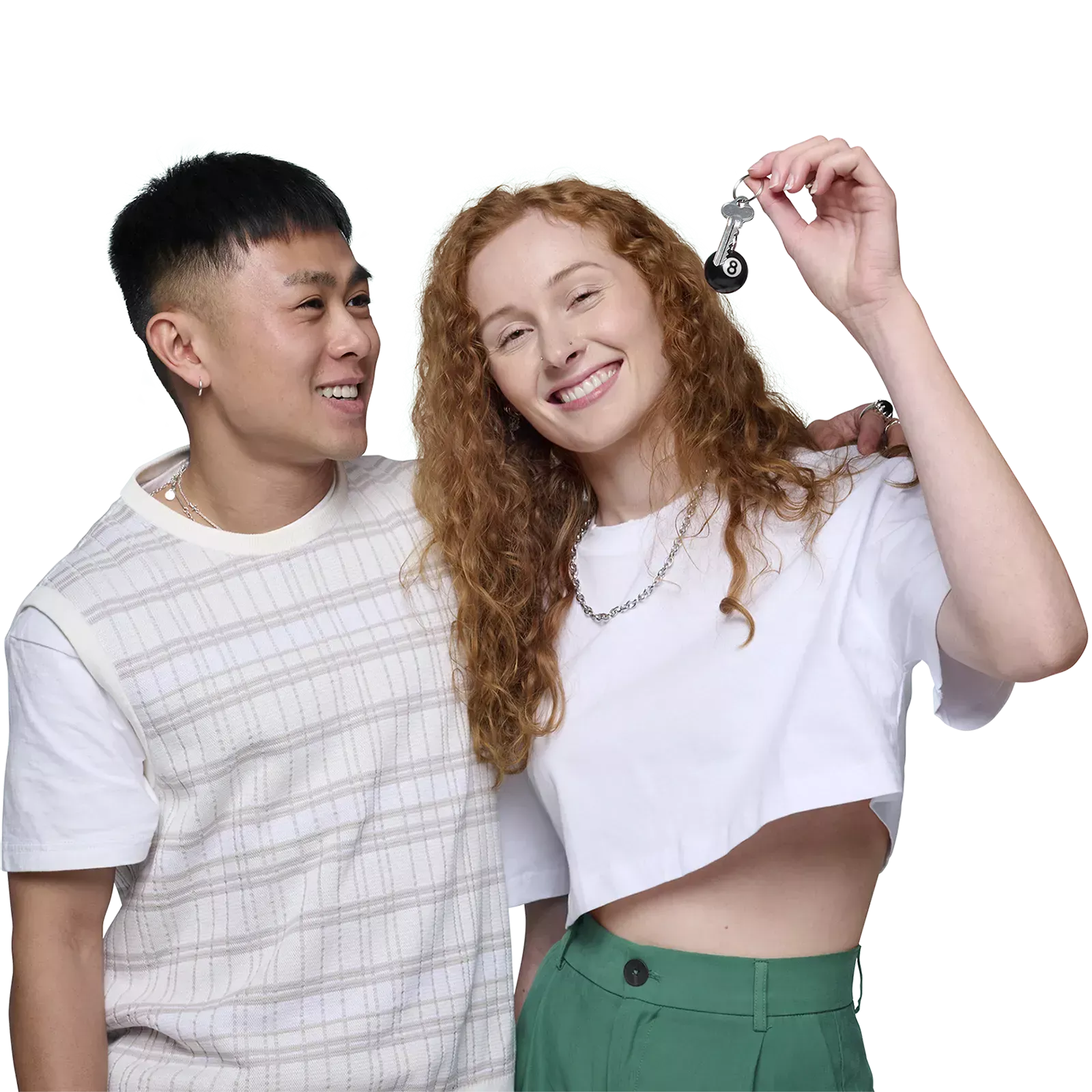 Smiling young male and female couple holding keys to their first home